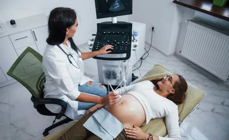 Doctor performing an ultrasound on a patient